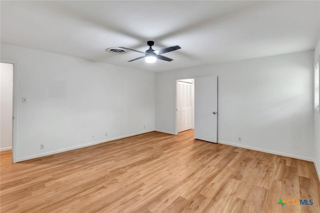 empty room featuring ceiling fan and light wood-type flooring