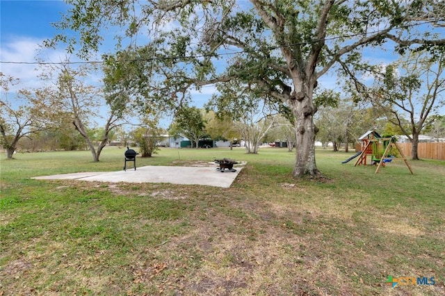 view of yard featuring a patio and a playground