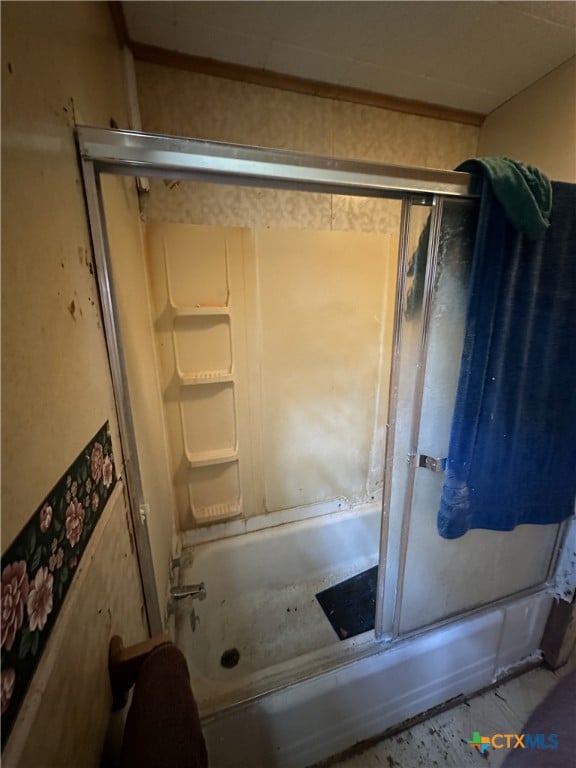 full bath featuring combined bath / shower with glass door