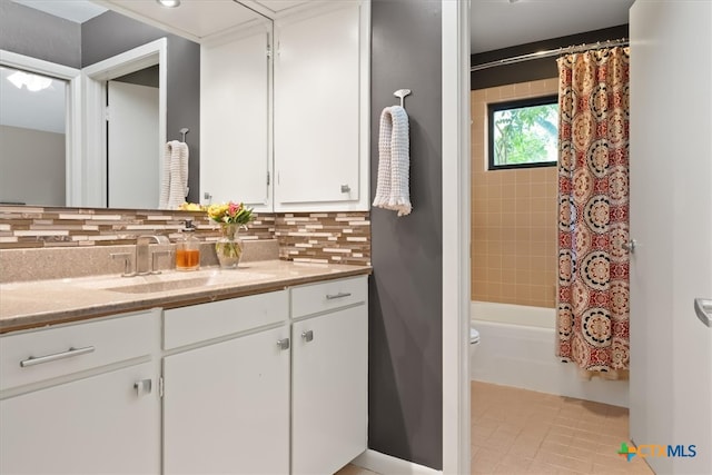 full bathroom featuring shower / bath combo, toilet, tile patterned floors, decorative backsplash, and vanity