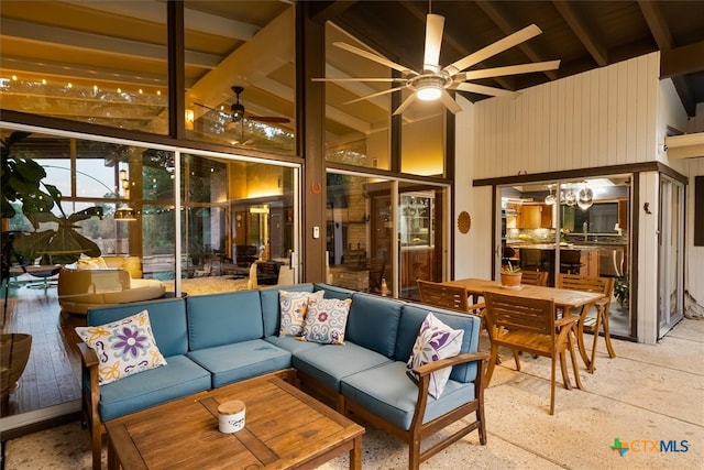 interior space featuring vaulted ceiling with beams and ceiling fan