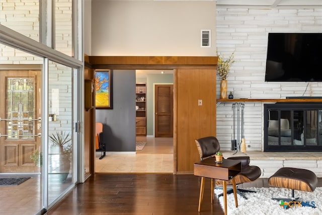 living room with hardwood / wood-style floors and a fireplace