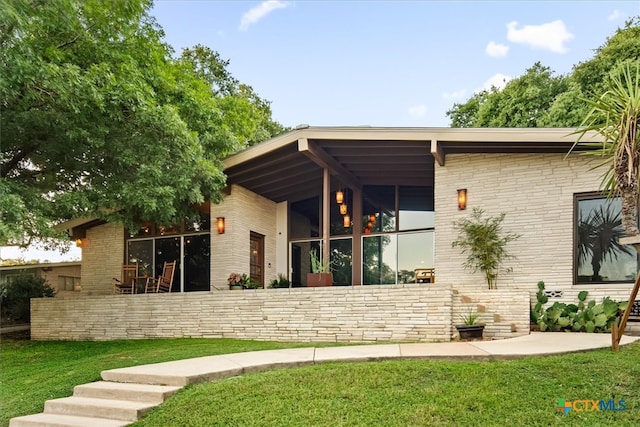 rear view of house with a yard