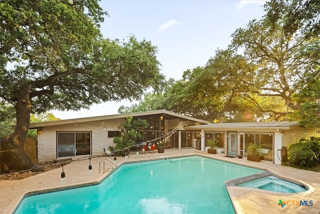 view of pool featuring an in ground hot tub and a patio area