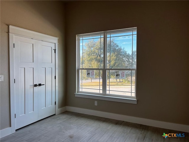 entrance foyer featuring plenty of natural light and light hardwood / wood-style floors