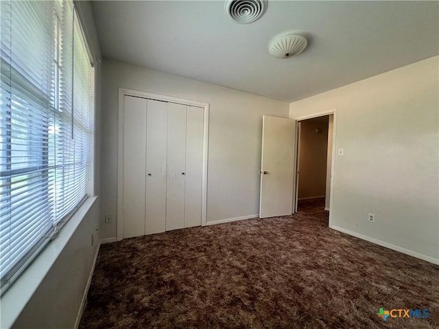 2809 Forest Trl, Temple, TX 76502 - unfurnished bedroom with multiple windows, carpet flooring, and baseboards