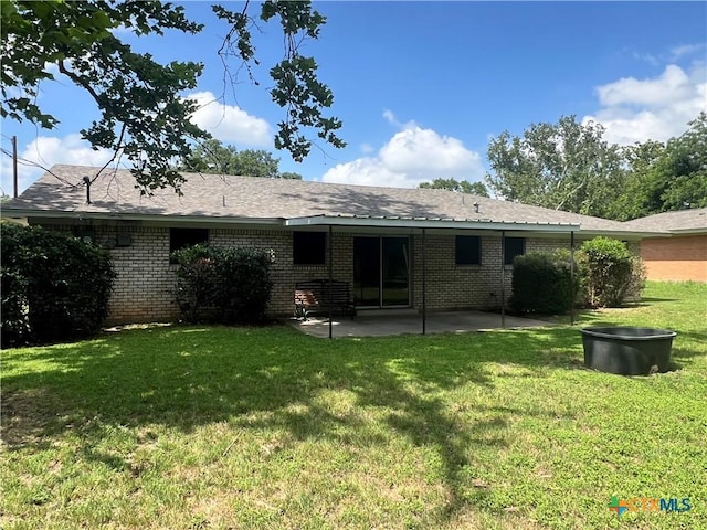 2809 Forest Trl, Temple, TX 76502 - rear view of house featuring a patio area, a lawn, and brick siding