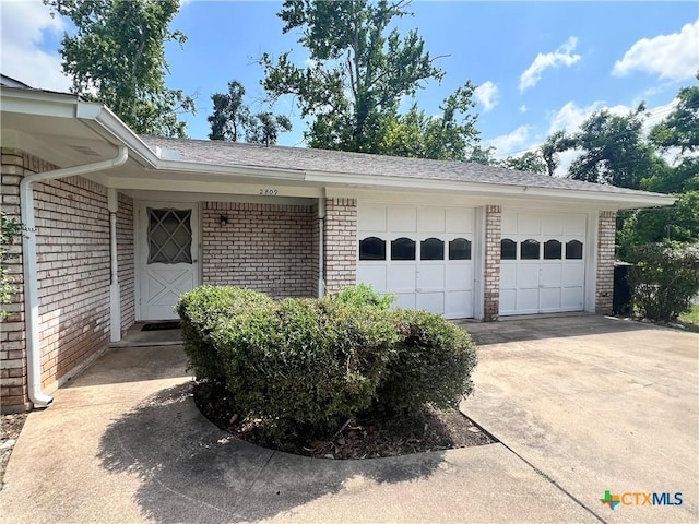 2809 Forest Trl, Temple, TX 76502 - view of property exterior with brick siding, concrete driveway, a garage, and a shingled roof