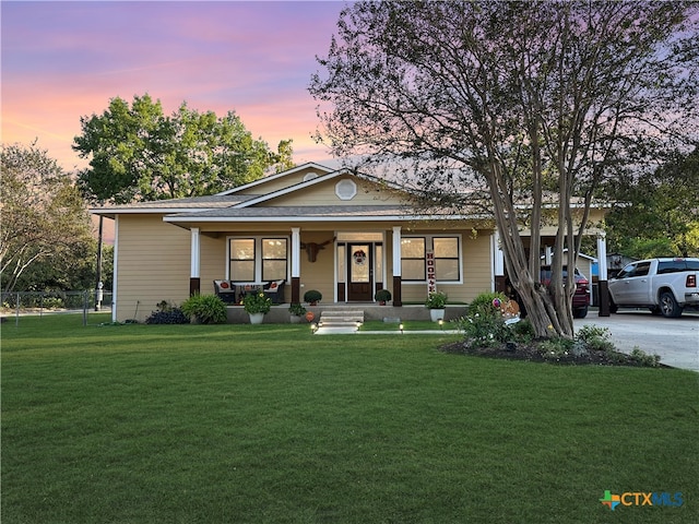 view of front of home featuring a lawn and a porch