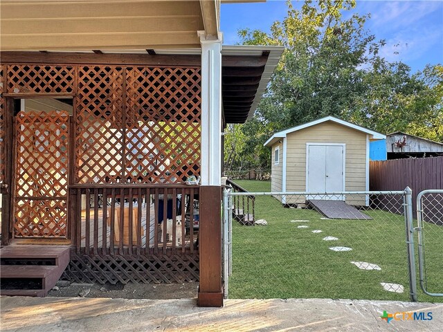 view of yard featuring a shed and a wooden deck