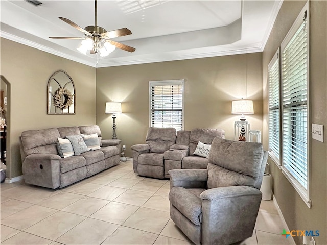 living room with ceiling fan, light tile patterned floors, and crown molding