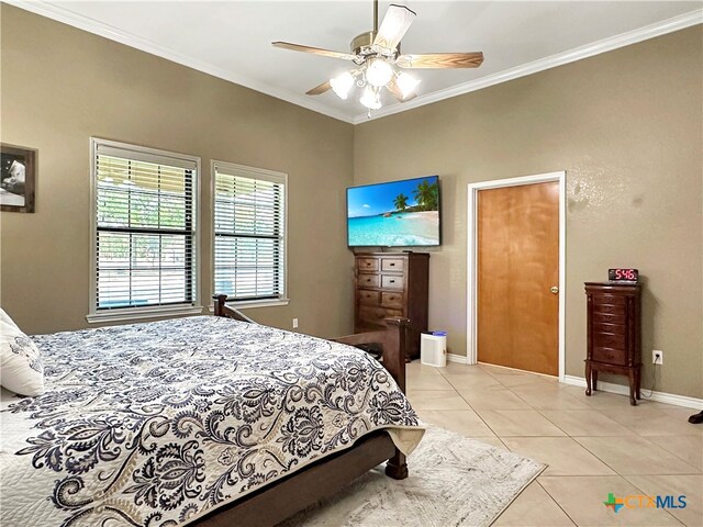 tiled bedroom featuring ceiling fan and ornamental molding