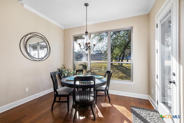 dining area featuring ornamental molding, plenty of natural light, and dark hardwood / wood-style flooring