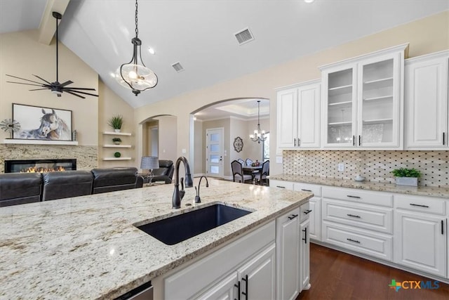 4012 Turning Leaf Dr, Nolanville, TX 76559 - kitchen with a sink, arched walkways, beam ceiling, open floor plan, and dark wood-style flooring