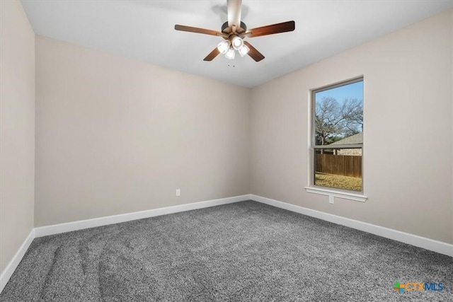 carpeted spare room featuring ceiling fan