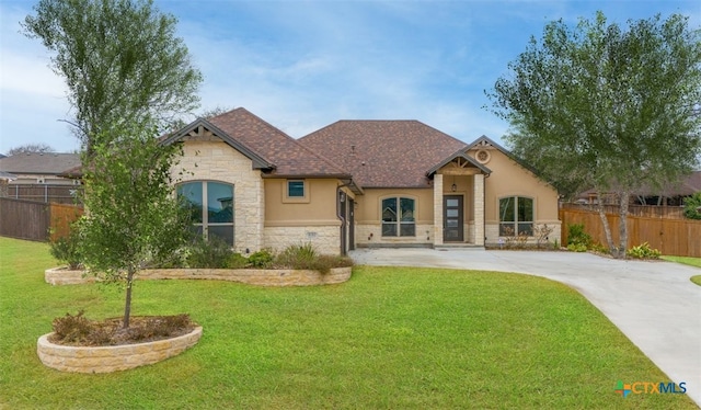 4012 Turning Leaf Dr, Nolanville, TX 76559 - french provincial home with stone siding, stucco siding, concrete driveway, and a shingled roof