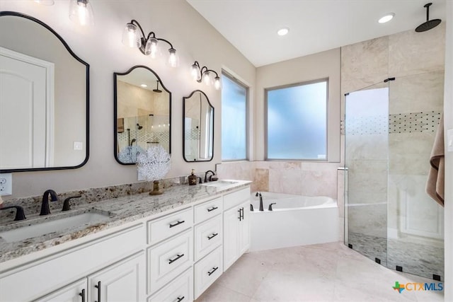 bathroom featuring separate shower and tub and vanity