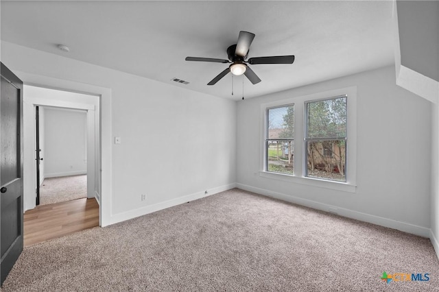 unfurnished bedroom featuring carpet flooring, baseboards, visible vents, and ceiling fan