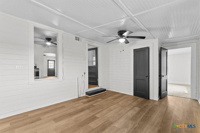 interior space featuring visible vents, ceiling fan, and wood finished floors