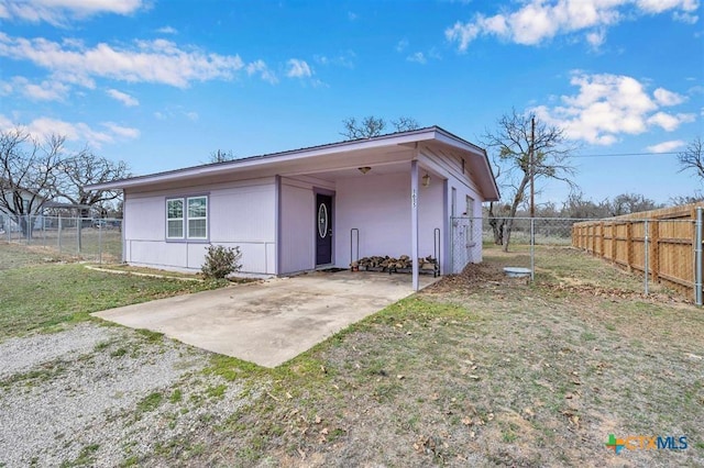 exterior space with a front lawn, fence private yard, and a patio