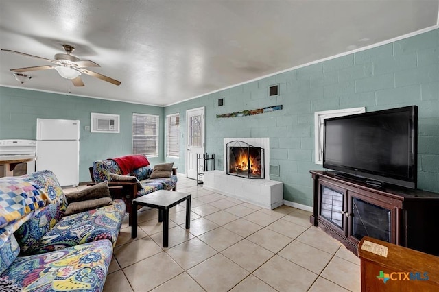 living area featuring light tile patterned floors, a fireplace, visible vents, and ornamental molding