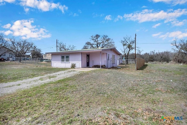 exterior space featuring a front yard, fence, and driveway