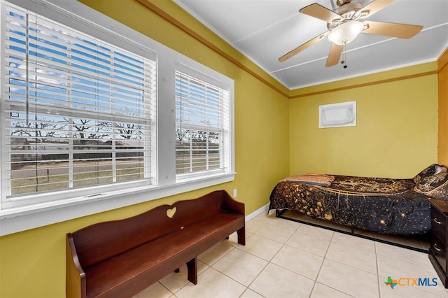 bedroom with baseboards, ceiling fan, crown molding, and tile patterned flooring