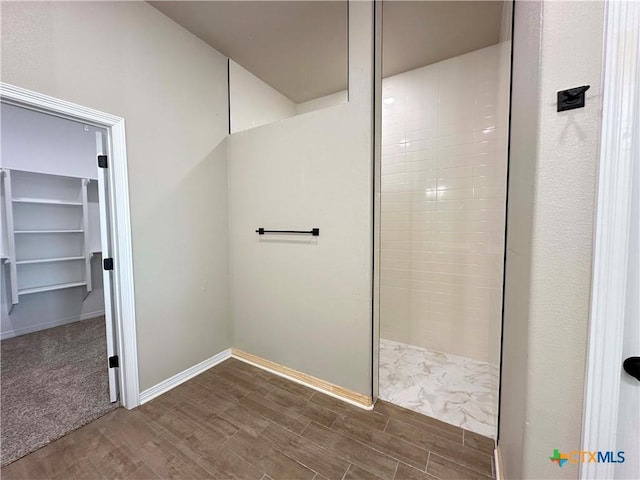 6132 Messina Dr, Temple, TX 76502 - bathroom featuring wood finished floors, walk in shower, and a spacious closet