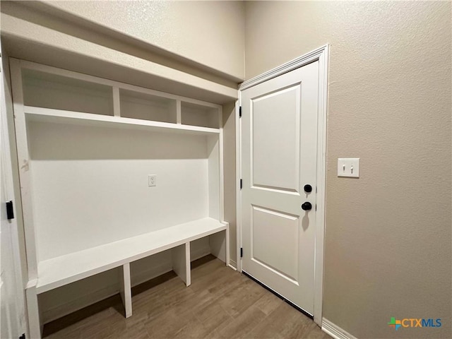 6132 Messina Dr, Temple, TX 76502 - mudroom featuring wood finished floors and a textured wall