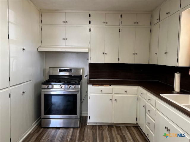 kitchen with gas stove, white cabinetry, and dark hardwood / wood-style floors