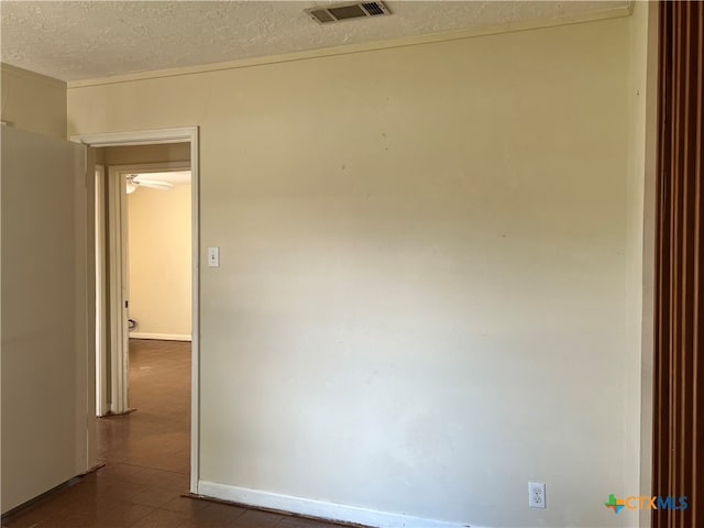 spare room with a textured ceiling