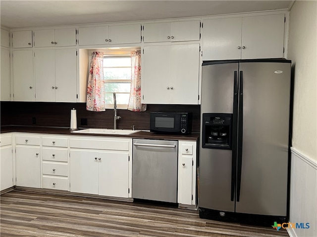 kitchen featuring white cabinetry, stainless steel appliances, sink, and dark hardwood / wood-style floors