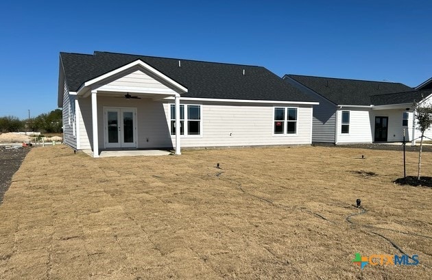 back of house featuring ceiling fan, a patio area, a lawn, and french doors