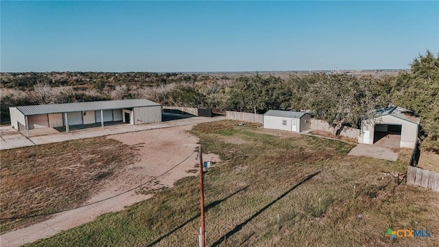 exterior space featuring an outbuilding, an outdoor structure, and fence