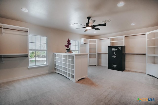 walk in closet with ceiling fan, carpet floors, and visible vents