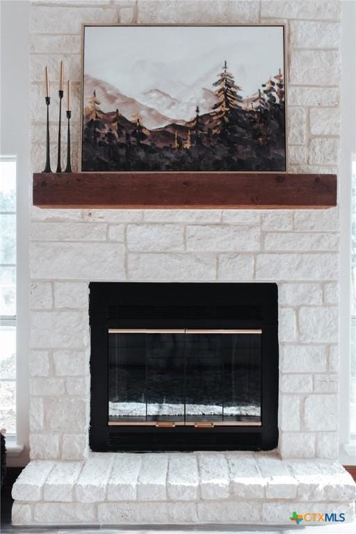 interior details featuring a fireplace with raised hearth