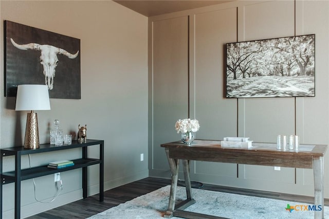 home office featuring baseboards and wood finished floors