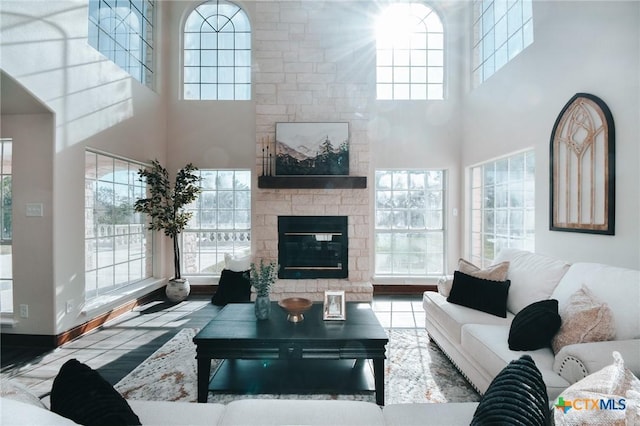 living area with plenty of natural light, a fireplace, and baseboards