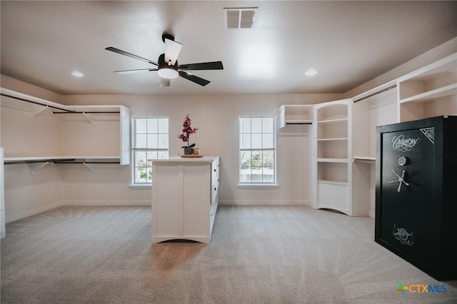 walk in closet with ceiling fan, visible vents, and carpet flooring