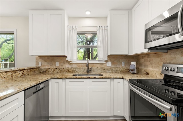 15118 Circle Oak St, San Antonio, TX 78232 - kitchen featuring appliances with stainless steel finishes, a sink, white cabinets, and light stone countertops