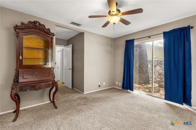15118 Circle Oak St, San Antonio, TX 78232 - unfurnished bedroom with access to outside, carpet, a textured ceiling, baseboards, and ceiling fan