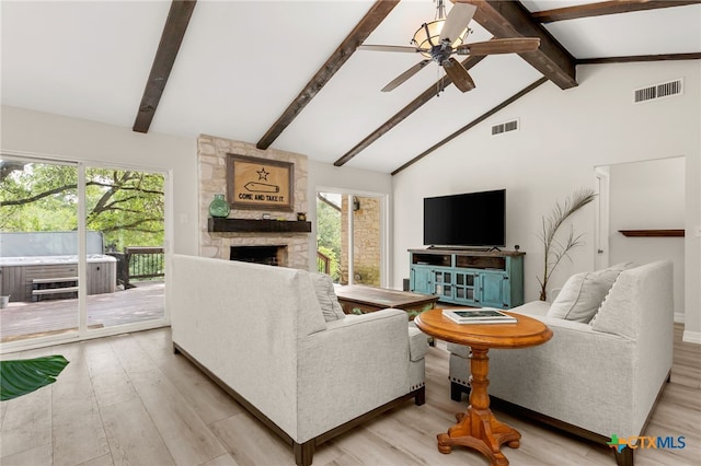 15118 Circle Oak St, San Antonio, TX 78232 - living area featuring a stone fireplace, a ceiling fan, wood finished floors, beamed ceiling, and healthy amount of natural light