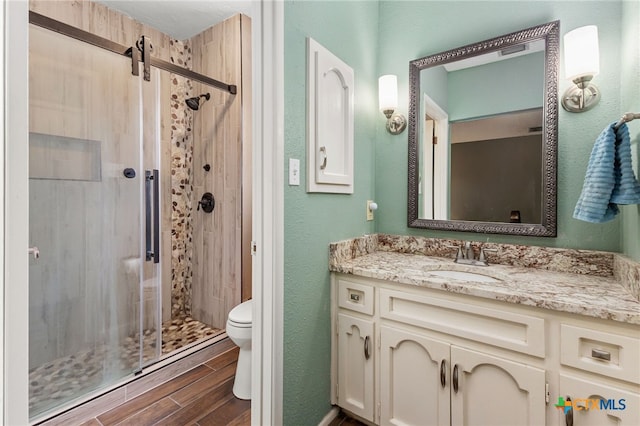 15118 Circle Oak St, San Antonio, TX 78232 - bathroom featuring a stall shower, toilet, wood finished floors, and vanity
