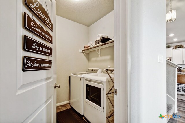 31696 Bard Ln, Bulverde, TX 78163 - laundry room featuring separate washer and dryer, dark wood-type flooring, baseboards, and a textured ceiling