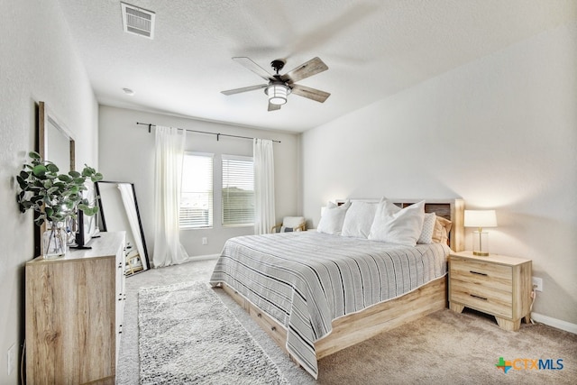 31696 Bard Ln, Bulverde, TX 78163 - bedroom featuring light colored carpet, baseboards, a ceiling fan, and a textured ceiling
