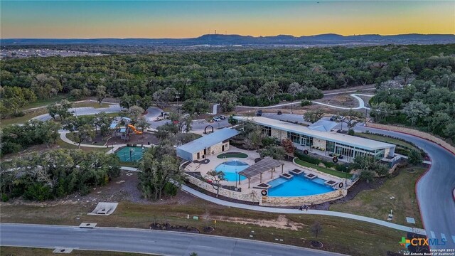 31696 Bard Ln, Bulverde, TX 78163 - bird's eye view of a pool area, a forest, and mountains