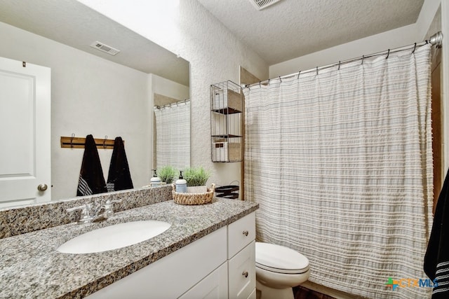 31696 Bard Ln, Bulverde, TX 78163 - bathroom with toilet, a textured ceiling, vanity, and a shower with shower curtain
