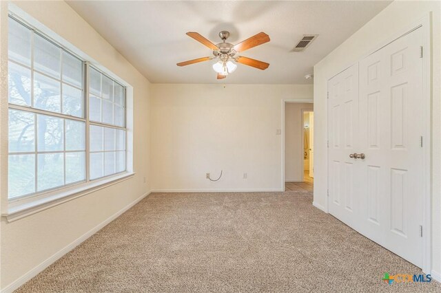 3302 Colorado Dr, Copperas Cove, TX 76522 - unfurnished bedroom featuring light colored carpet, baseboards, a closet, and a ceiling fan