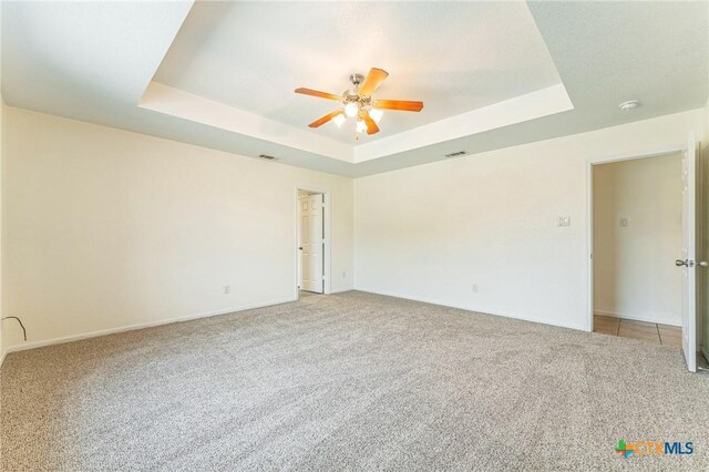 3302 Colorado Dr, Copperas Cove, TX 76522 - empty room with a raised ceiling, light colored carpet, a ceiling fan, and baseboards
