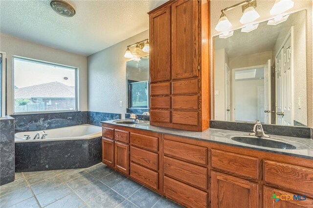 3302 Colorado Dr, Copperas Cove, TX 76522 - full bath with a textured ceiling, a bath, double vanity, and tile patterned flooring